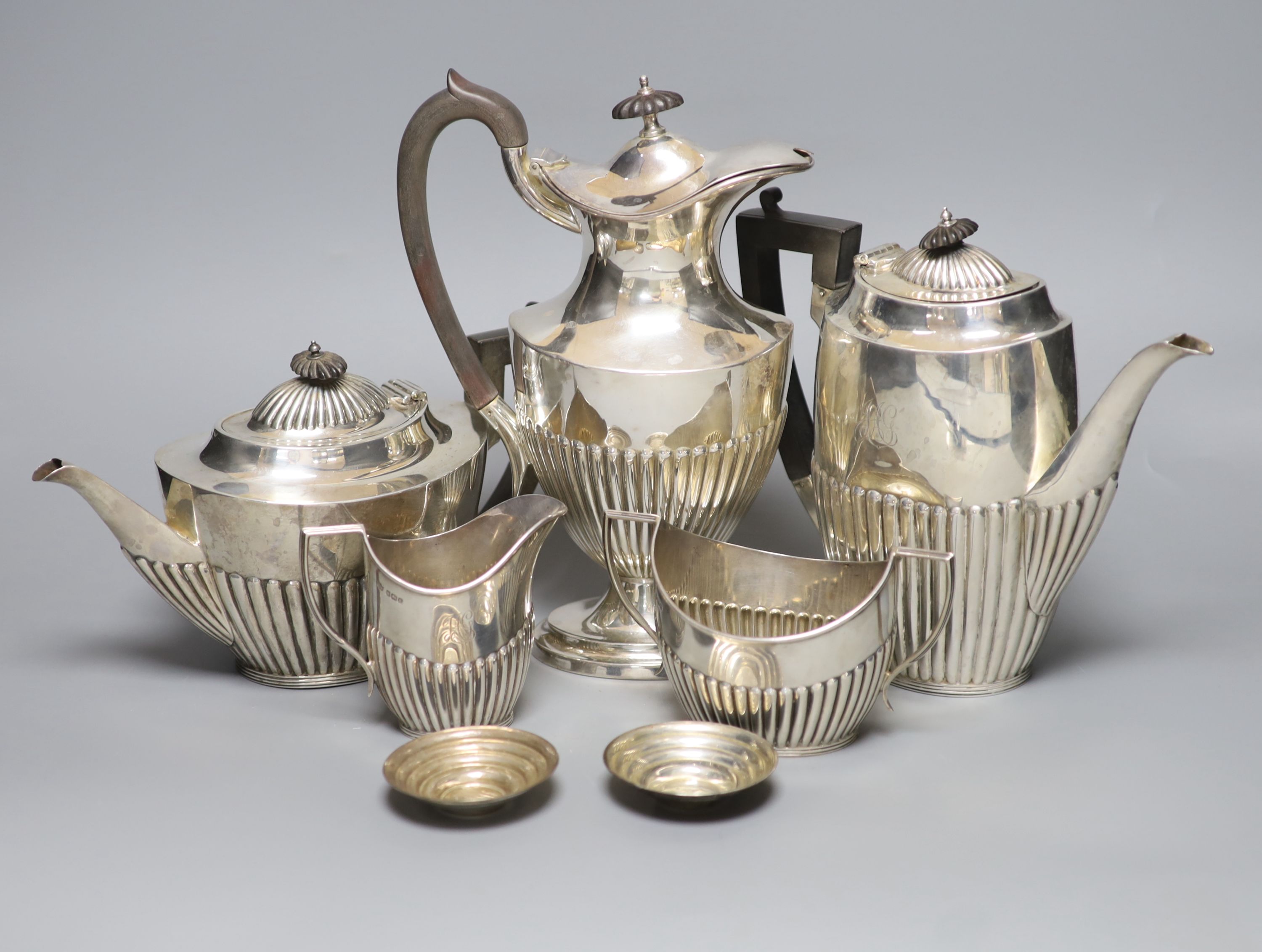 A George V demi fluted silver four piece tea and coffee service, Mappin & Webb, Sheffield, 1912, a matched plated hot water pot and two small 925 dishes
